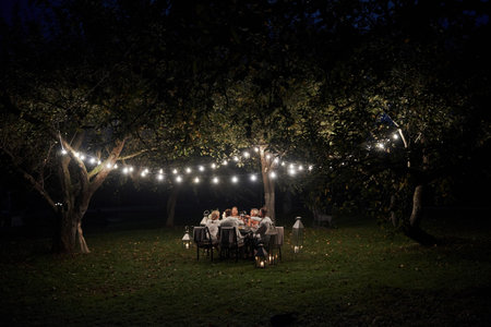 Such a beautiful field. Evening time. Friends have a dinner in the gorgeous outdoor place.