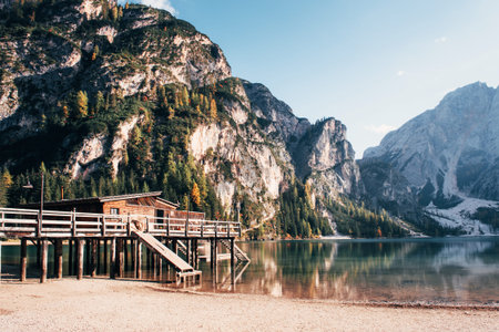 Good landscape with mountains. Touristic place with wooden building and pear.