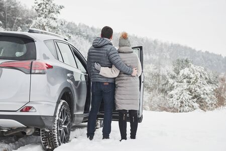 Traveling and resting. Lovely couple have weekend at countryside at winter time.の写真素材