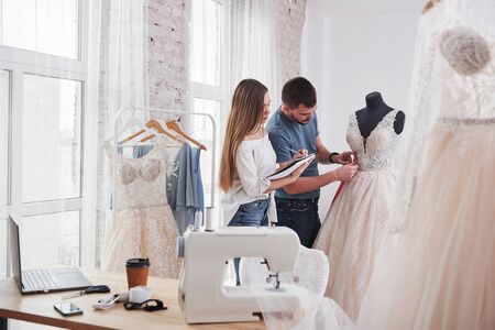 Notes in the textbook. The process of fitting the dress in the studio of hand crafted clothes.の写真素材