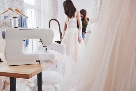 Focused photo. The process of fitting the dress in the studio of hand crafted clothes.の写真素材