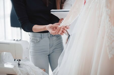 Work in progress. The process of fitting the dress in the studio of hand crafted clothes.の写真素材