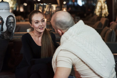 Interesting conversation. Girl with her boyfriend have nice evening at beautiful restaurant.の写真素材