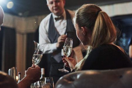 Making an order. Girl with her boyfriend have nice evening at beautiful restaurant.