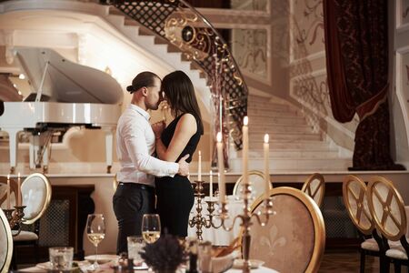 Pure sincere love. Beautiful couple have romantic dinner in luxury restaurant at evening time.の写真素材