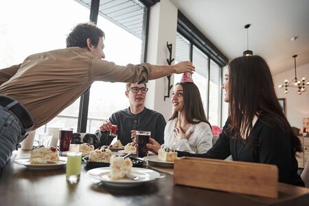 Heres your hat. One of employees have birthday today. Friendly coworkers decided to make surprise for her.の写真素材