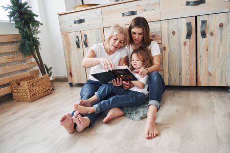 Ths will help you to know world around you better. Mother, grandmother and daughter having good time in the kitchen.の写真素材