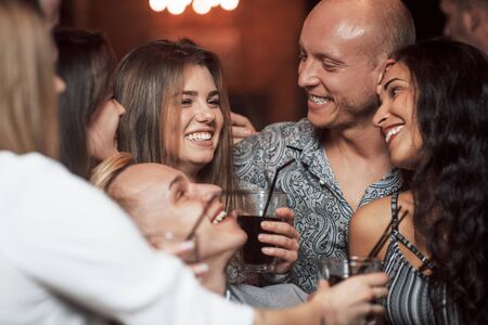 Finally weekend. Beautiful youth have party together with alcohol in the nightclub.の写真素材