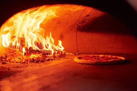 Process of cooking. Fire burning in the furnace. Close up view of wood in flames.の写真素材