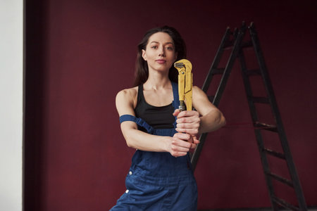 Lets do this. Young housewife decided to glue wallpaper in her new house in the room.の写真素材