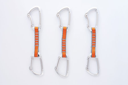 For sale. Many of the multi colored carabiners on lying on the white table.