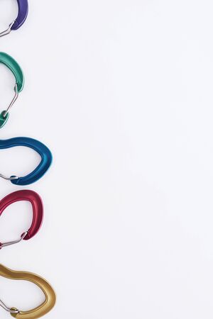 For the climbing. Many of the multi colored carabiners on lying on the white table.の写真素材