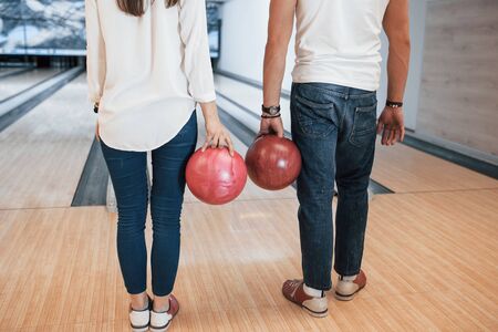 In jeans and white shirts. Cropped view of people at the bowling club ready to have some fun.の写真素材