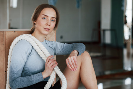 Good looking personal trainer. Sportive young woman have fitness day in the gym at morning time.