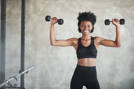 Conception of strength. Studio shot of young woman that stands in front of grey background with...