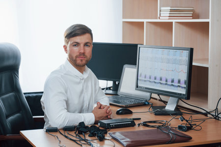 In the workplace. Polygraph examiner works with his lie detectors equipment.