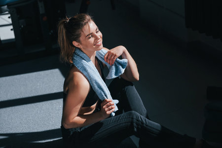 Sweaty but happy. Photo of gorgeous blonde woman in the gym at her weekend time.