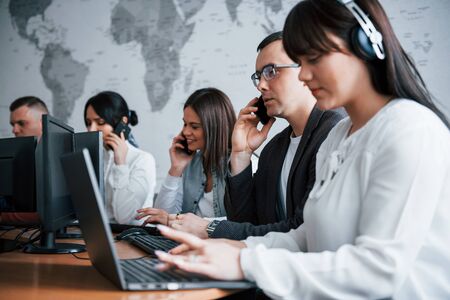 Man in eyewear have some deals. Young people working in the call center. New deals is coming.の写真素材