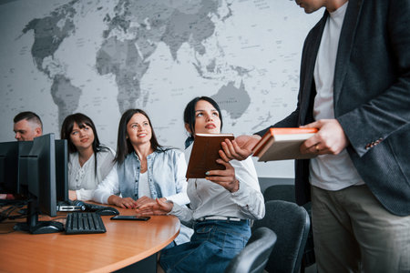 You better write it. Group of people at business conference in modern classroom at daytime.