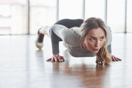 Hard working. Sportive young woman have fitness day in the gym at morning time.
