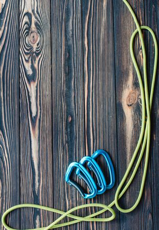 For the alpinism. Isolated photo of climbing equipment. Parts of carabiners lying on the wooden table.の写真素材