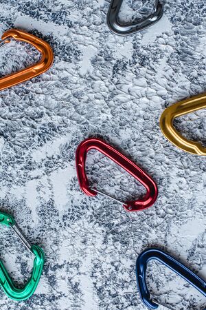Nice colors. Isolated photo of climbing equipment. Part of carabiner lying on the white and grey colored surface.の写真素材