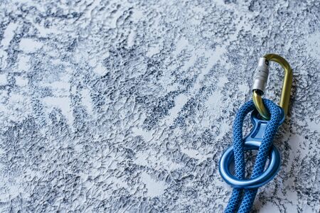 Particle view. Isolated photo of climbing equipment. Part of carabiner lying on the white and grey colored surface.の写真素材