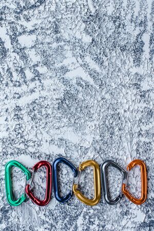 For your tastes. Isolated photo of climbing equipment. Part of carabiner lying on the white and grey colored surface.の写真素材