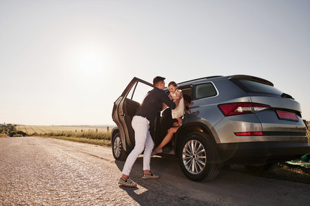 Going out. Beautiful people is in the modern car at their weekends.