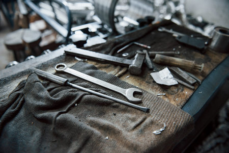 Place of work. Tools on dirty table. In garage. Manufactory conception.