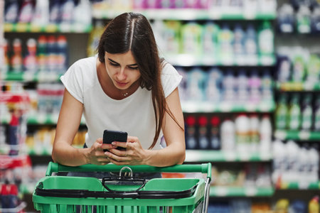 Female shopper in casual clothes in market looking for products.