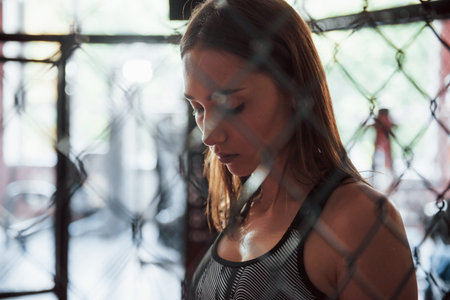 Feels exhausted. Taking a break. Sportswoman at boxing ring have exercise.の写真素材