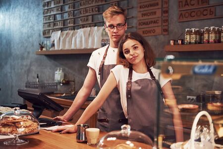 Happy people. Two young cafe workers indoors. Conception of business and service.の写真素材