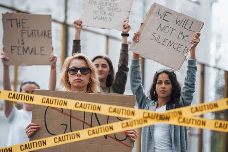 Displeased people. Group of feminist women have protest for their rights outdoors.の写真素材