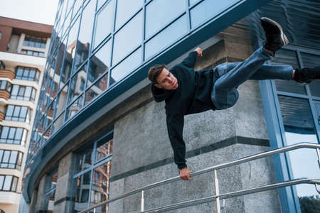 Young man doing parkour in the city at daytime. Conception of extreme sports.の写真素材