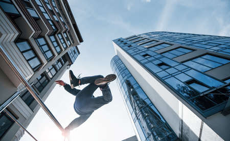 Young man doing parkour in the city at daytime. Conception of extreme sports.の写真素材