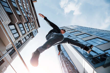 Young man doing parkour in the city at daytime. Conception of extreme sports.の写真素材