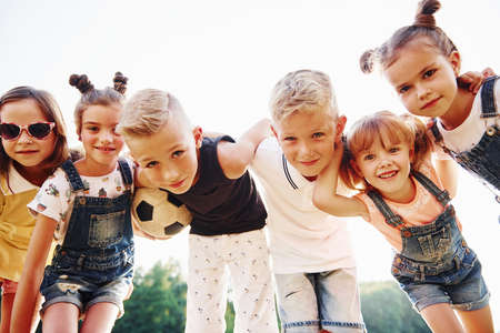 With soccer ball. Portrait of kids that standing together and posing for the camera.の写真素材