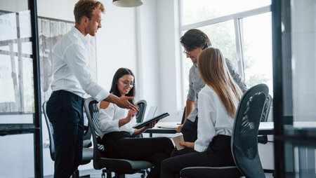 Young business people in formal clothes working in the office.