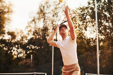 Game in action. Young tennis player in sportive clothes is on the court outdoors.