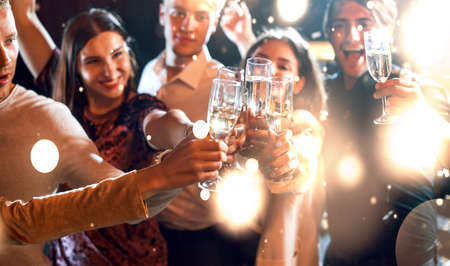 Group of cheerful young people have party and celebrating new year indoors.の写真素材