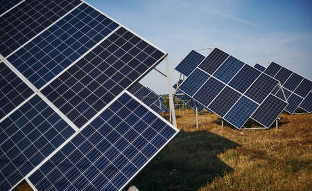 Field with solar batteries at sunny daytime. Conception of ecology and fuel.の写真素材