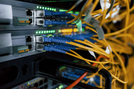 Close up view of internet equipment and cables in the server room.の写真素材