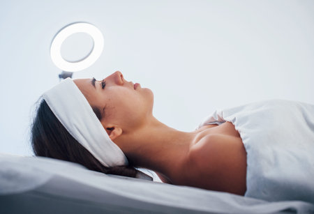 Close up view of woman that lying down in spa salon and have face cleaning procedure.