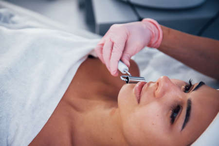 Close up view of woman that lying down in spa salon and have face cleaning procedure.の写真素材
