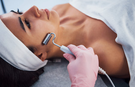 Close up view of woman that lying down in spa salon and have face cleaning procedure.