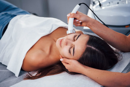 Close up view of woman that lying down in spa salon and have face cleaning procedure.