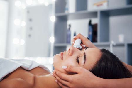 Close up view of woman that lying down in spa salon and have face cleaning procedure.の写真素材