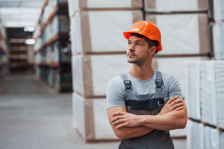 Portrait of young worker in unifrorm that is in warehouse.の写真素材