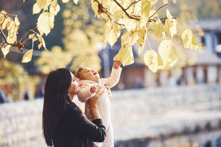 Mother in casual clothes with her child is in the park.の写真素材